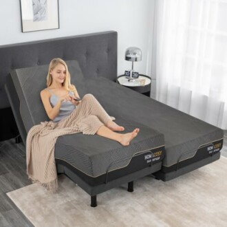 Woman relaxing on an adjustable bed with a remote control.